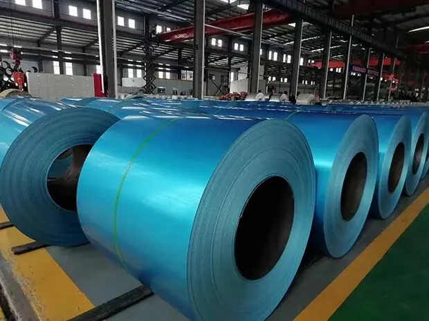 Blue and green color coated steel coils lined up in a plant