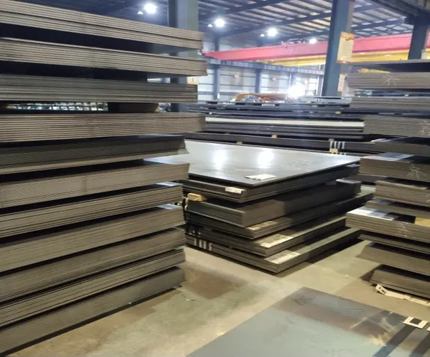 stacks of steel plates stored indoors in a warehouse aisle