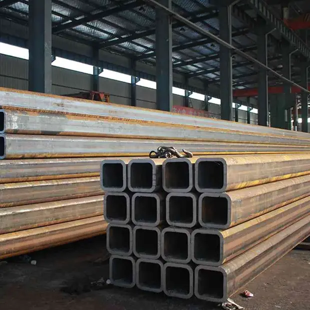 Bundle of square steel tubes stacked inside a steel-framed shed