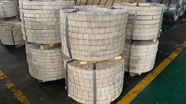 Bundled narrow steel strip coils strapped and stacked on the floor
