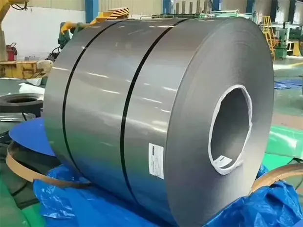 Single steel coil standing on end with label on blue sheeting