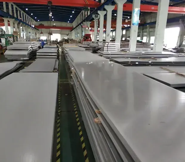 Long stainless steel sheets stacked along a warehouse aisle