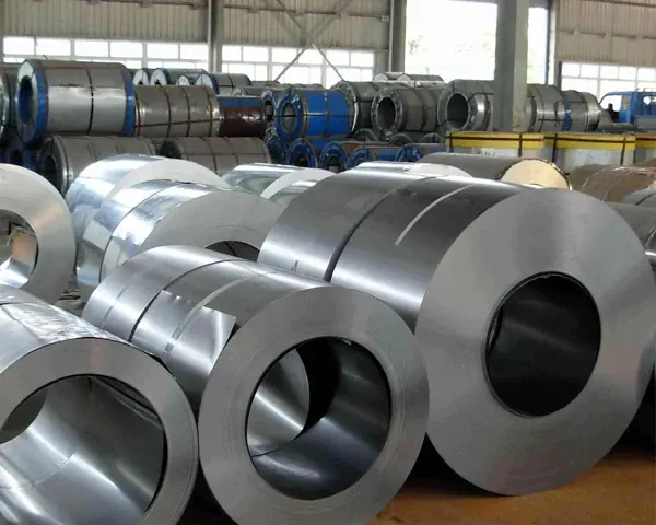 Cold rolled steel coils stored in a mill hall behind processing lines