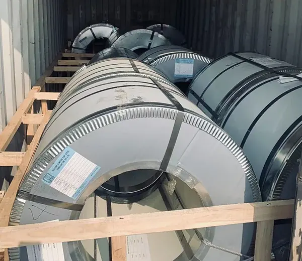 Steel coil packed upright in a wooden crate with a label
