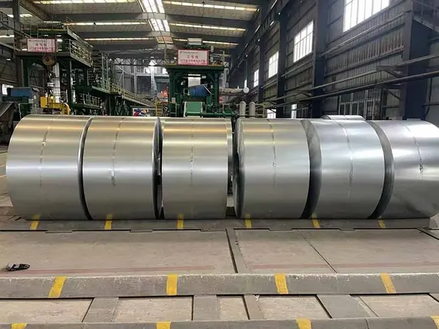 Rows of steel coils stored on a mill floor