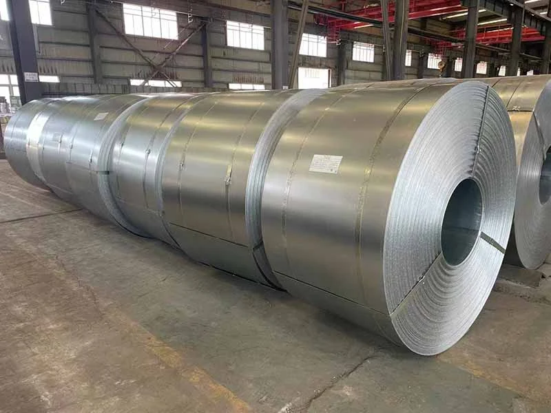 Large galvanized steel coil standing on a warehouse floor