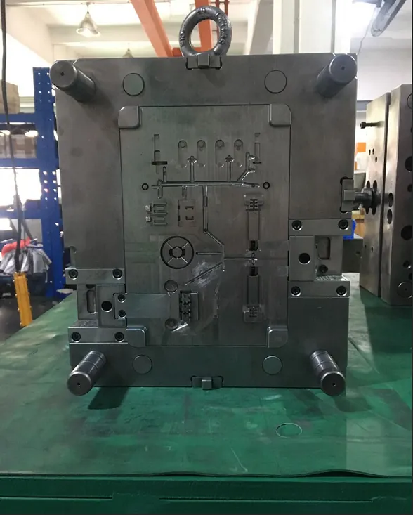 Assembled injection mould standing on the fitting bench with guide pillars and slides