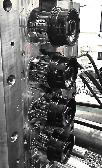 Multi-cavity mould half with four round cavity inserts and cooling circuits