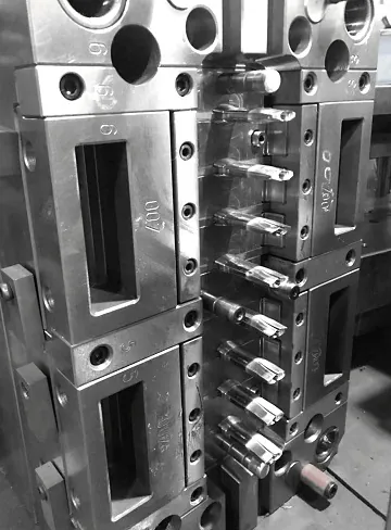 Machined mold inserts photographed on the About page