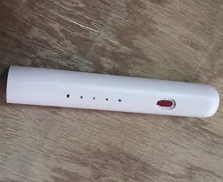 White cylindrical handle with four indicator holes and a red slider