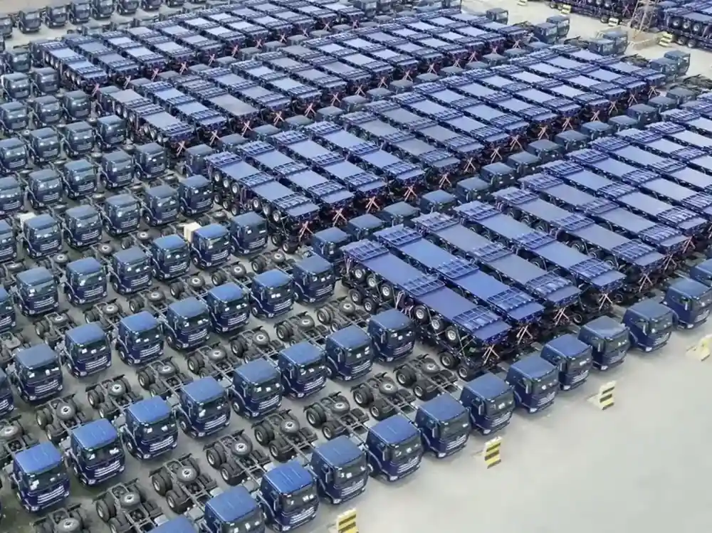 Rows of completed SINOHENG trailer chassis and tractor units in the factory yard before delivery