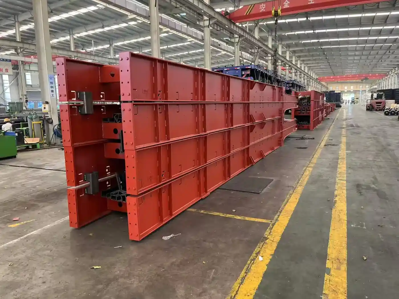 Welded trailer main beams under the overhead crane inside the SINOHENG fabrication hall