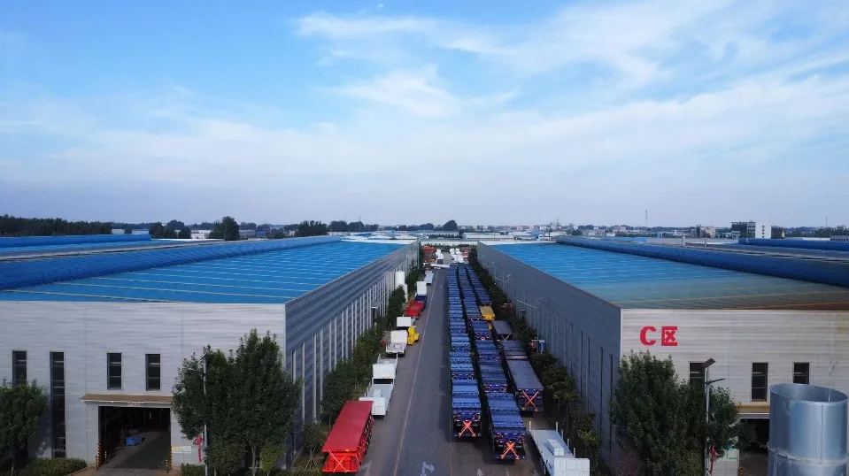 Aerial view of the SINOHENG trailer factory with finished semi trailers lined up between the production halls