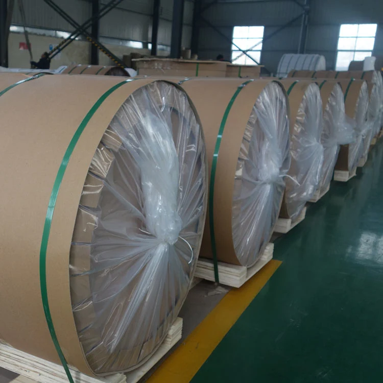 Paper-wrapped conductor coils staged for a transformer production order