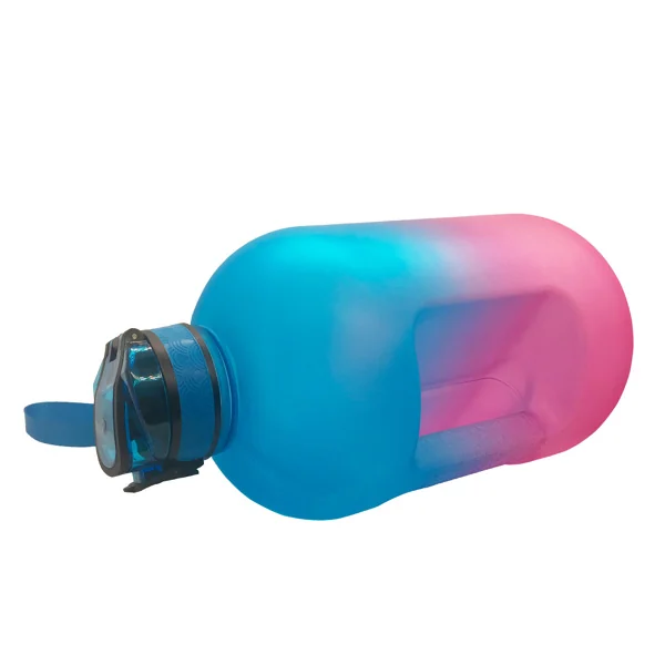 Large 1 gallon sports water bottle with blue-to-pink gradient body and blue flip-top lid, shown lying on its side.