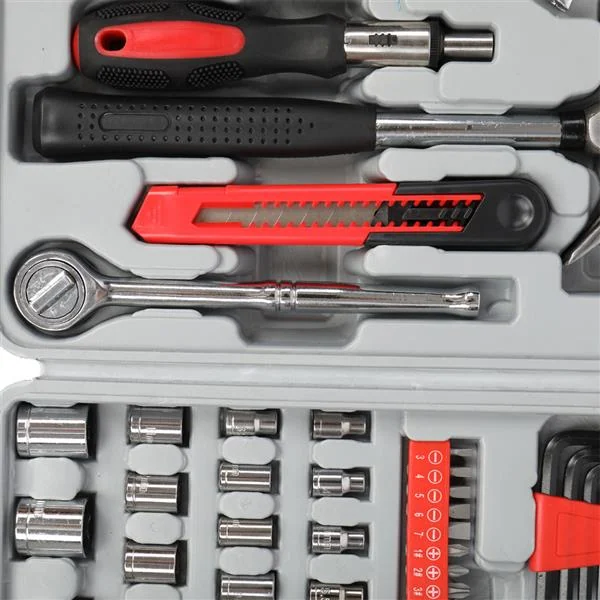 Close-up of grey tool kit case with screwdrivers, utility knife, ratchet wrench, chrome sockets and hex keys