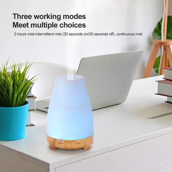 Diffuser in use with mist rising and lights changing between green, blue, and purple