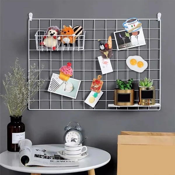 White wire grid wall organizer with 3D food magnets including cupcake and eggs holding cards and plants