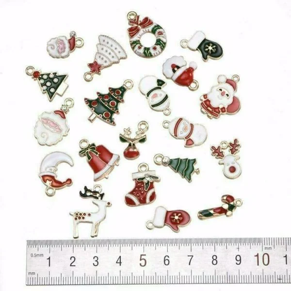 Assorted Christmas enamel alloy pendants including Santa, tree, and reindeer with a ruler for scale