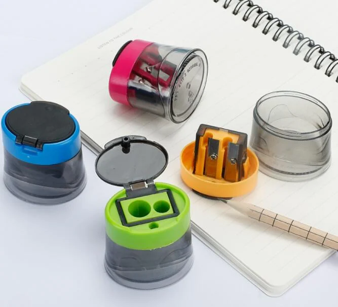 Round double-hole pencil sharpener in a bright custom colour, sitting on a desk