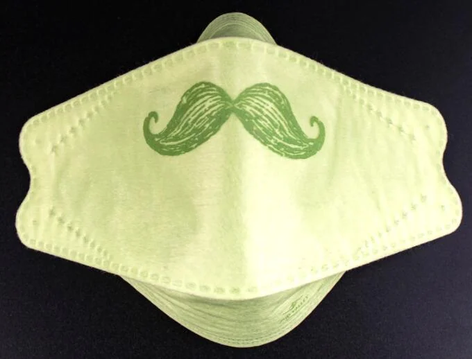 Pale green 3D disposable KN95-style face mask with a printed green mustache design, shown on a dark background