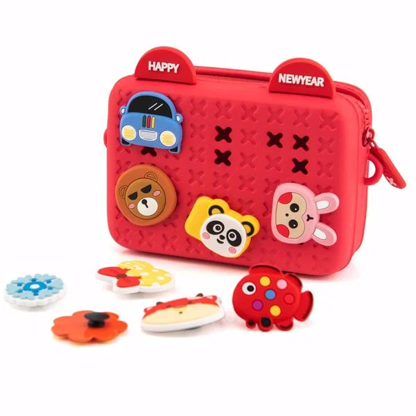 Red silicone toddler crossbody bag with cartoon animal charms, including bear, panda and bunny badges, on white background
