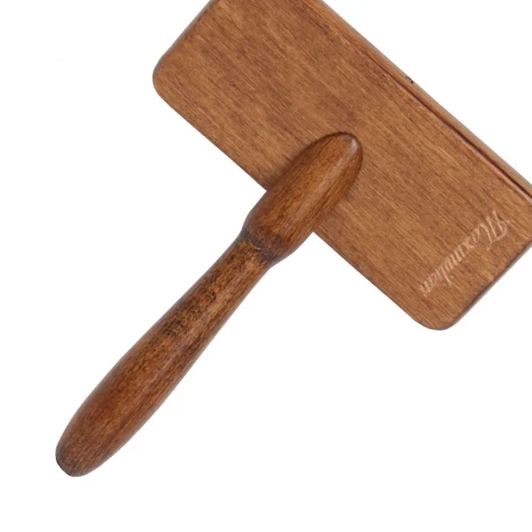Wooden pet slicker grooming brush with turned wooden handle shown at an angle on a white background, brand name printed on the body.