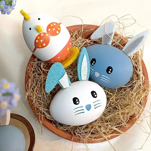 Easter eggs displayed in a basket with other seasonal decorations