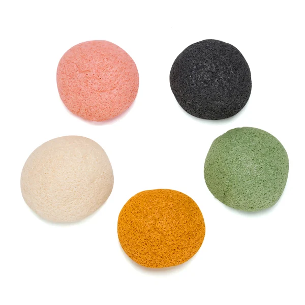 Sponge being used with facial cleanser on a hand in circular motion