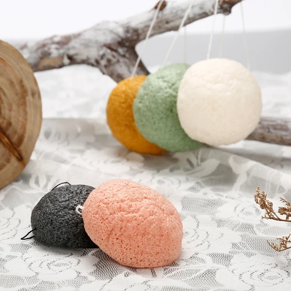 Set of konjac sponges with different mineral additives, laid out on a white surface