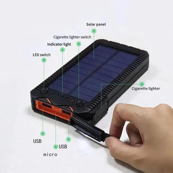 Black solar power bank on white background with labeled features: solar panel, USB ports, LED switch and cigarette lighter.