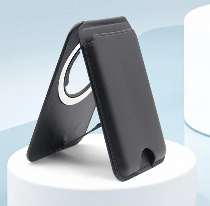 Black leather magnetic phone card holder folded into a stand on a white pedestal against a light blue