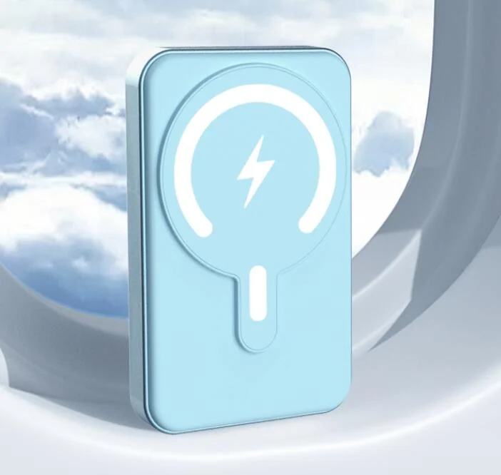 Light blue MagSafe-style magnetic wireless power bank with white lightning bolt charging symbol on a cloudy sky backdrop