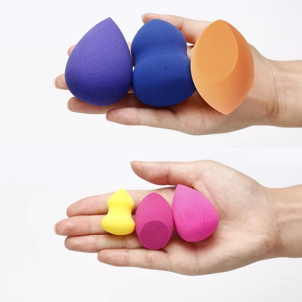 Wet makeup sponge being rinsed under a tap