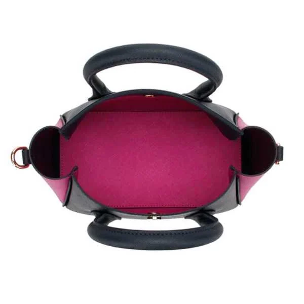 Top view of an open mini black handbag showing a bright pink interior lining with dual black rolled handles