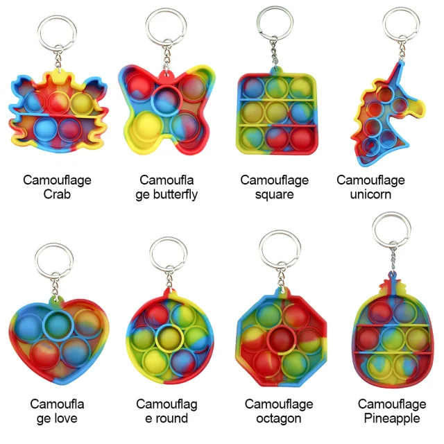 A catalog of eight silicone pop-it fidget keychains in various camouflage shapes including a crab, butterfly, unicorn, and pineapple.