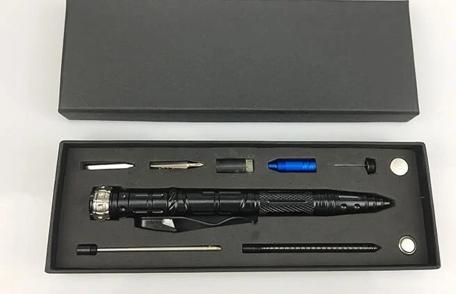 Black tactical multifunctional pen with refills, fire starter and accessories laid out in a foam-lined gift box