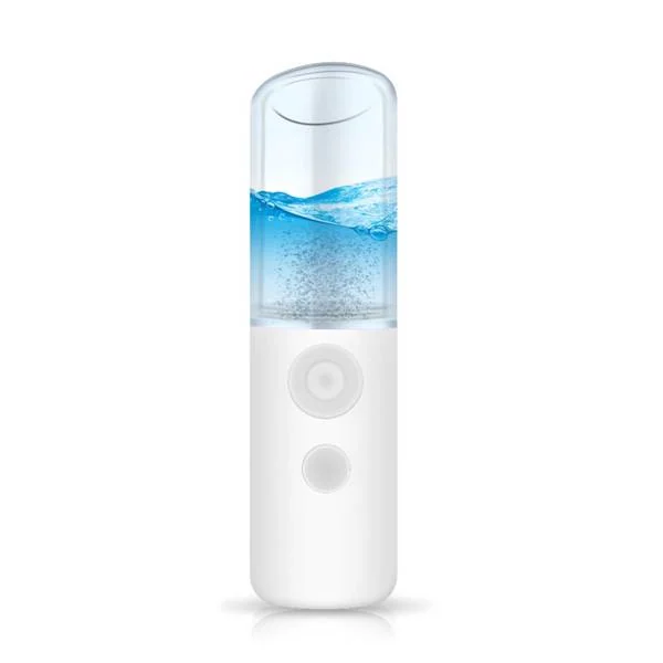 Portable nano facial mister in hand, sprayer nozzle releasing fine mist into the air