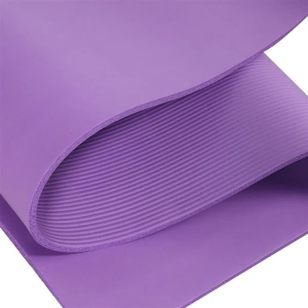 Yoga mat next to a water bottle and towel, indicating use in a home or studio