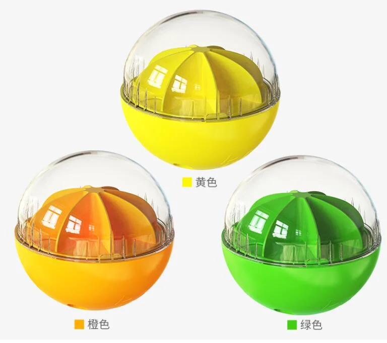 Three wobble wag giggle dog balls in yellow, orange, and green displayed against a white background