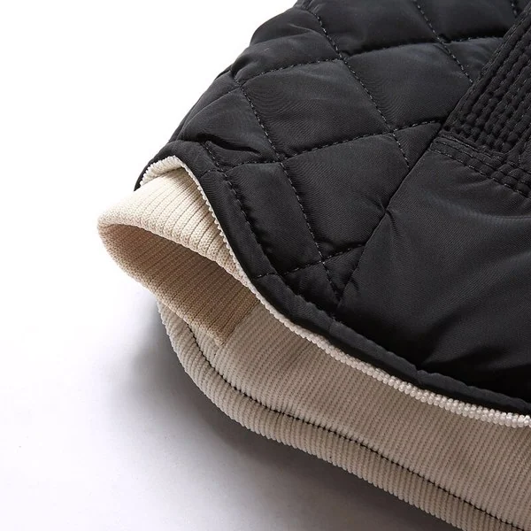 Vest laid flat on a table, showing the size chart and fabric detail