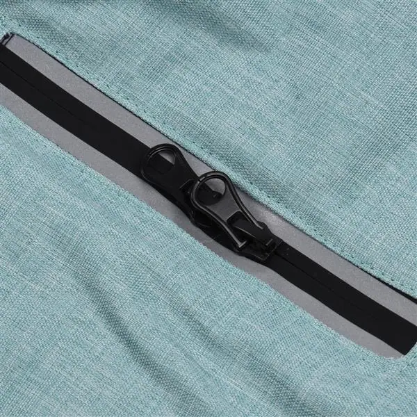 Close-up of a black zipper pull on the mint green heathered fabric of a dog jacket with a reflective strip