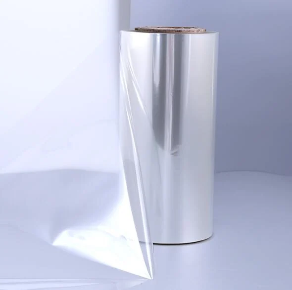 Roll of glossy transparent PET thermal lamination film with a corner of film peeled away, studio product shot