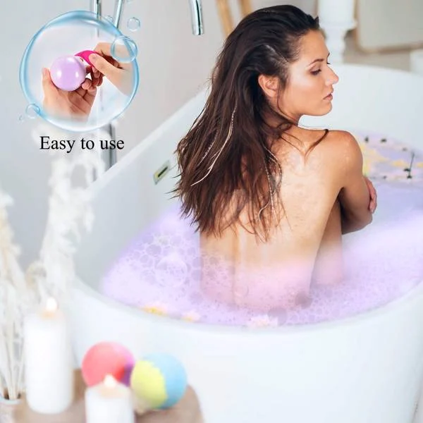 Top-down view of the bath bomb cake with a hand placing it in a bath