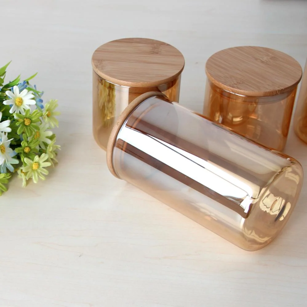 Amber glass food storage jars with bamboo lids, one jar lying on its side beside small white flowers