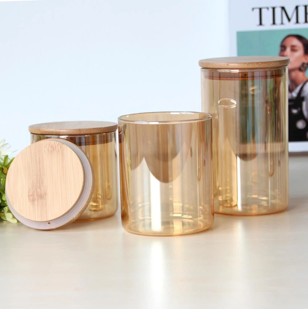 Three amber glass food storage jars with round bamboo lids on a white table, one lid leaning against a jar.