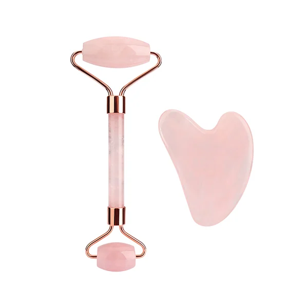 Rose quartz face roller with rose gold frame beside a heart-shaped gua sha stone on a white background