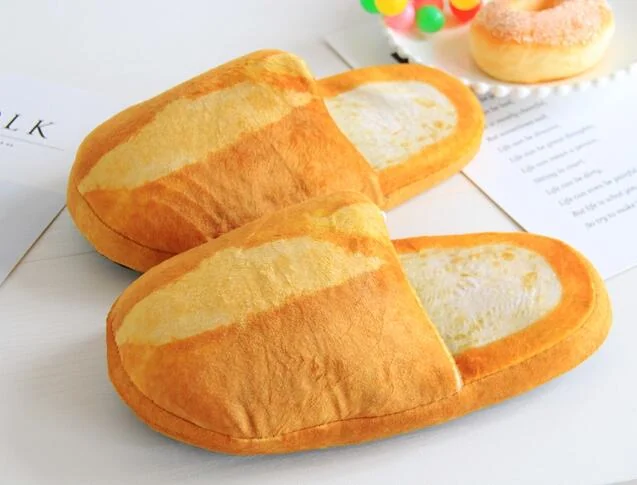 Pair of bread slippers placed side by side, one in Women’s M and one in Men’s L