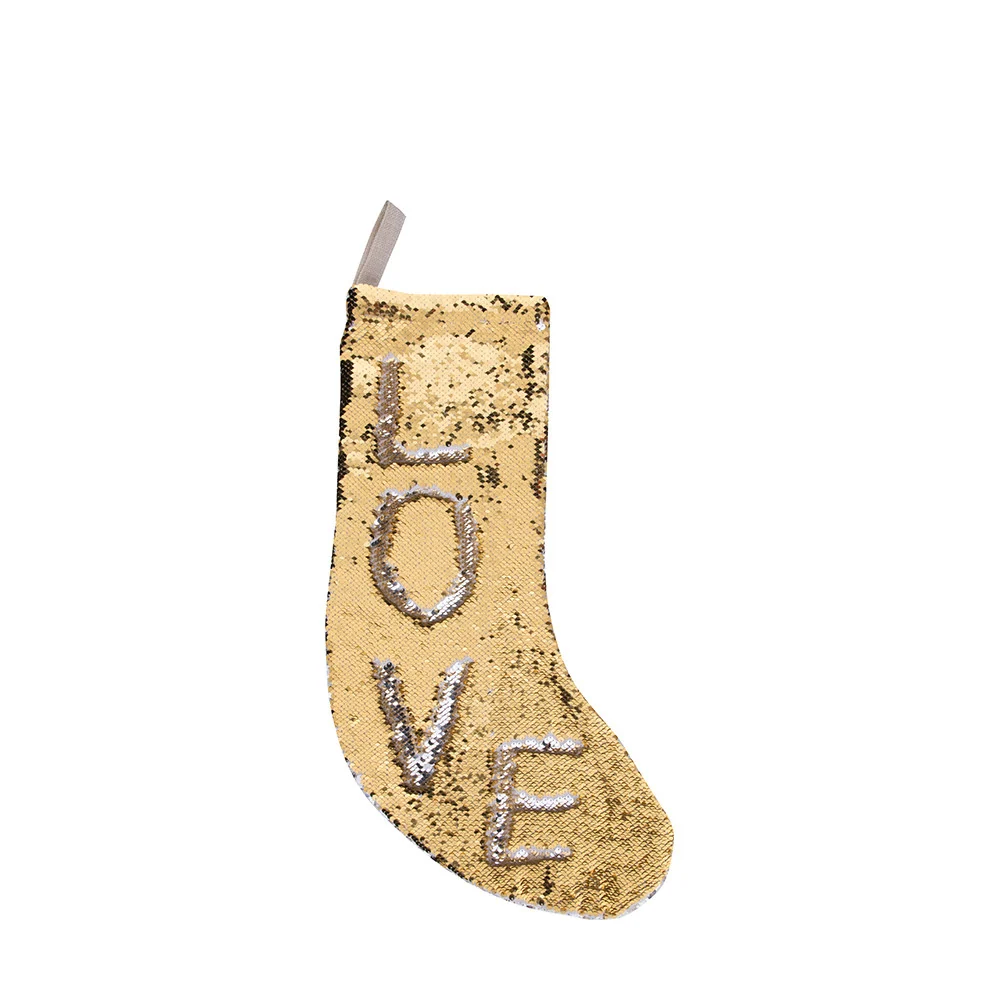 Gold sequin Christmas stocking with silver LOVE lettering spelled in flip sequins, hanging loop visible