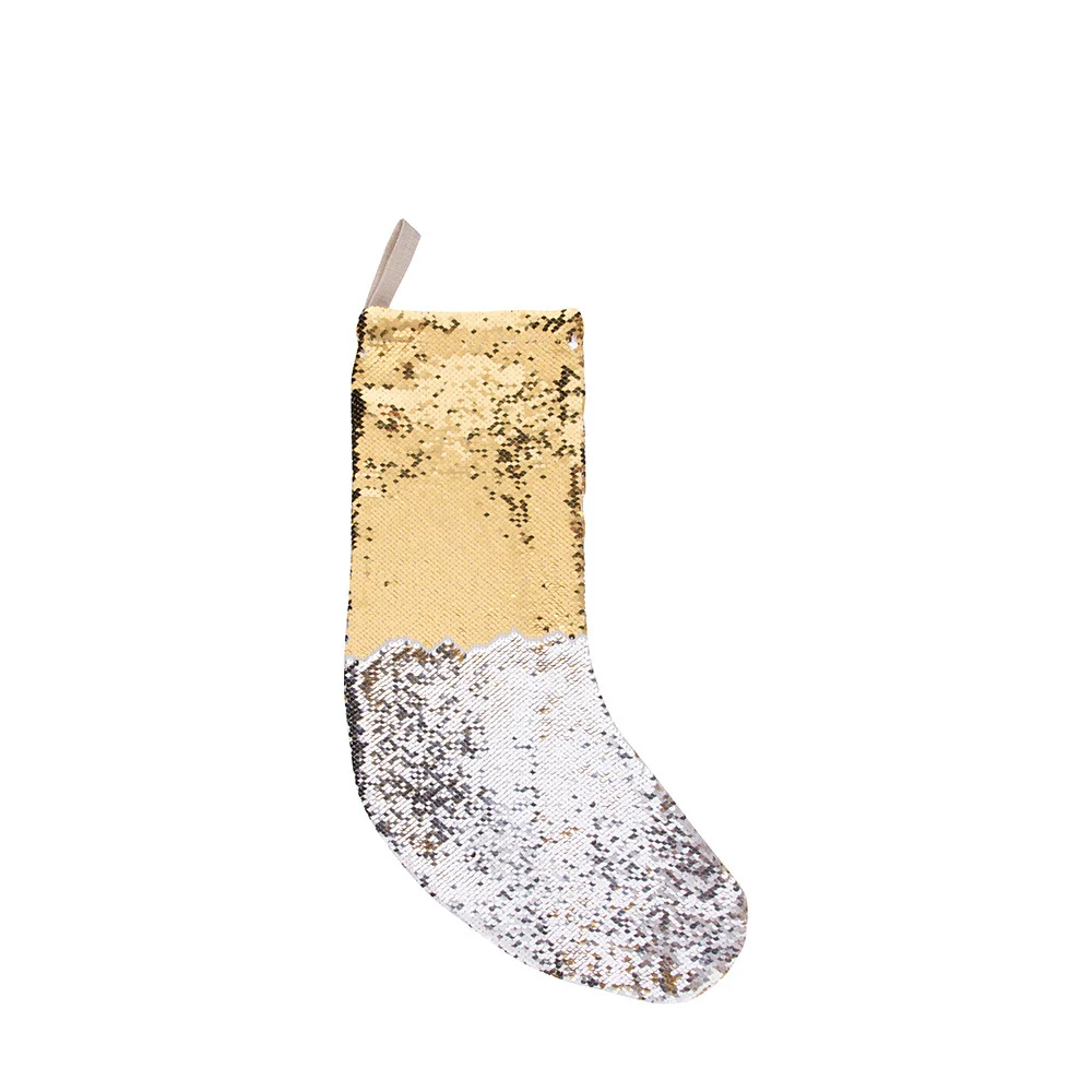Gold and silver reversible sequin Christmas stocking with hanging loop on a plain white background